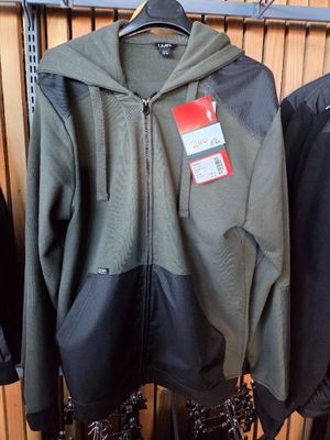 two jackets hanging on a rack in a store