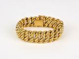 a gold chain bracelet with a square clasp on a white background