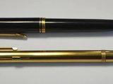 two pens sitting next to each other on a table
