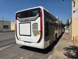 a white bus that is parked on the side of the street