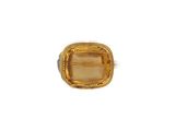 Gros plan sur une bague contenant une pierre jaune