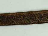 an old knife with a wooden handle on a white surface