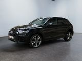 a black audi suv parked in a showroom