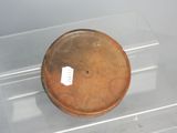 a glass display case with a brown bowl on it
