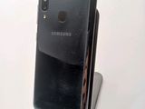 a close up of a cell phone on a stand on a table
