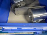 a blue container with some metal items in it