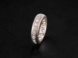 a close up of a diamond ring on a black surface