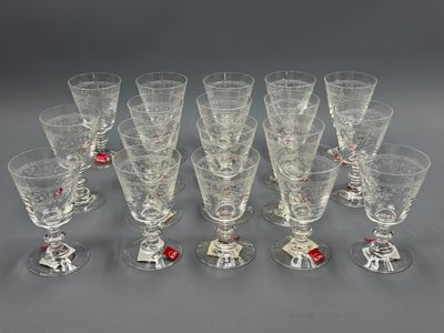 twelve wine glasses with red and white decorations on them