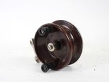 a close up of a wooden reel on a white surface