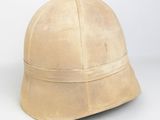 an old helmet on a white surface with a white background