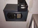 a metal box with a combination lock on it in a bathroom