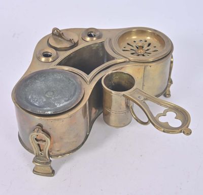 an old brass plate with a teapot on top of it