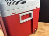 a red and white cooler sitting on a wooden table