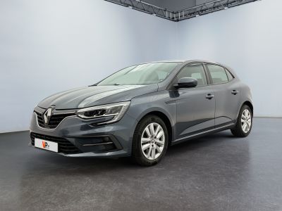 a grey car is parked in a room with a white wall
