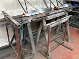 many pieces of metal sitting on a table in a workshop