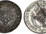 a silver coin with a crown on top of it