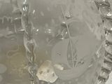 a glass ball with a chain around it on a table