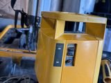 a yellow machine that is sitting in a garage