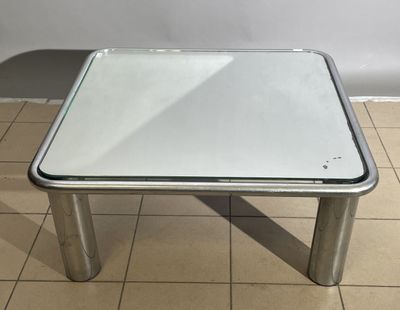 a small table with a glass top on a tiled floor