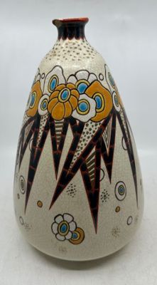 a vase with a design on it sitting on a table