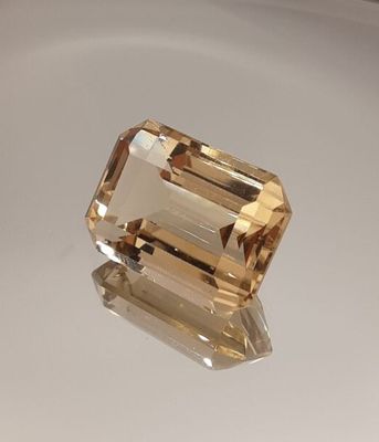 a yellow topazte gems on a white surface