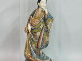 a figurine of a woman under a glass dome