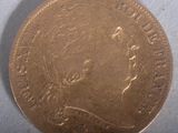 a close up of a coin on a table with a white background