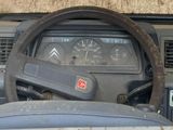 steering wheel and dashboard of a truck with dirt on top of it
