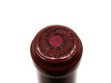 a close up of a wine bottle on a white surface