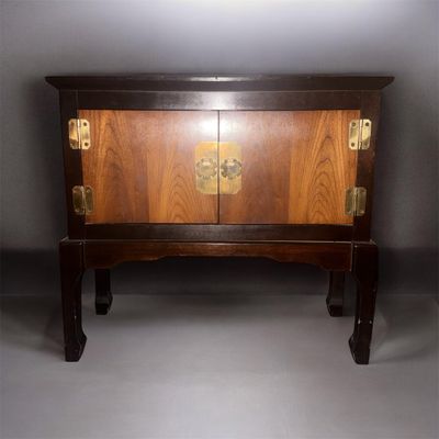 an image of a wooden cabinet with brass hardware on it
