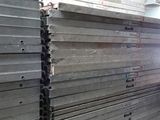 a large amount of steel bars stacked up in a warehouse