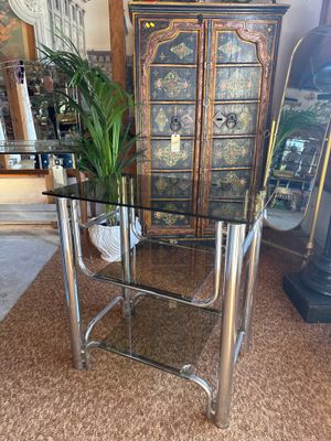 a glass table with a potted plant on top of it