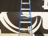 a ladder that is standing in front of a wall