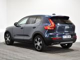 the back end of a blue volvo suv parked on a checkered floor