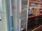 a refrigerator that is sitting in the corner of a room