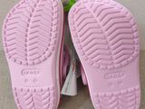 a pair of pink shoes that are next to a pair of scissors