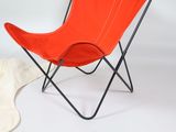 a red chair with a black frame on a white background