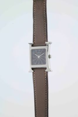 an image of a close up of a wrist watch with a brown strap