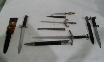 several different types of knives are displayed on a white surface