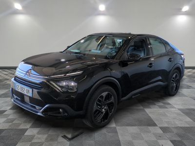a black suv parked in a garage with a checkered floor