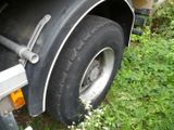 a truck that has a flat tire on the side of the road