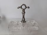 a glass tray with a silver object on top of it