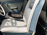 a blue and white car with a black seat in the back of it