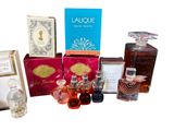 many different perfumes and perfume bottles on a white surface