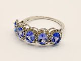 an image of a ring with tan and blue stones