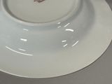 a white plate with a red and white design on it