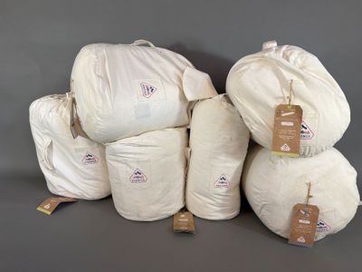 several bags of white cotton are stacked on top of each other