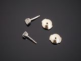 three screws and a bolt on a black surface