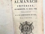 un livre ouvert sur lequel figure un blason