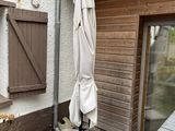 an umbrella that is sitting outside of a house